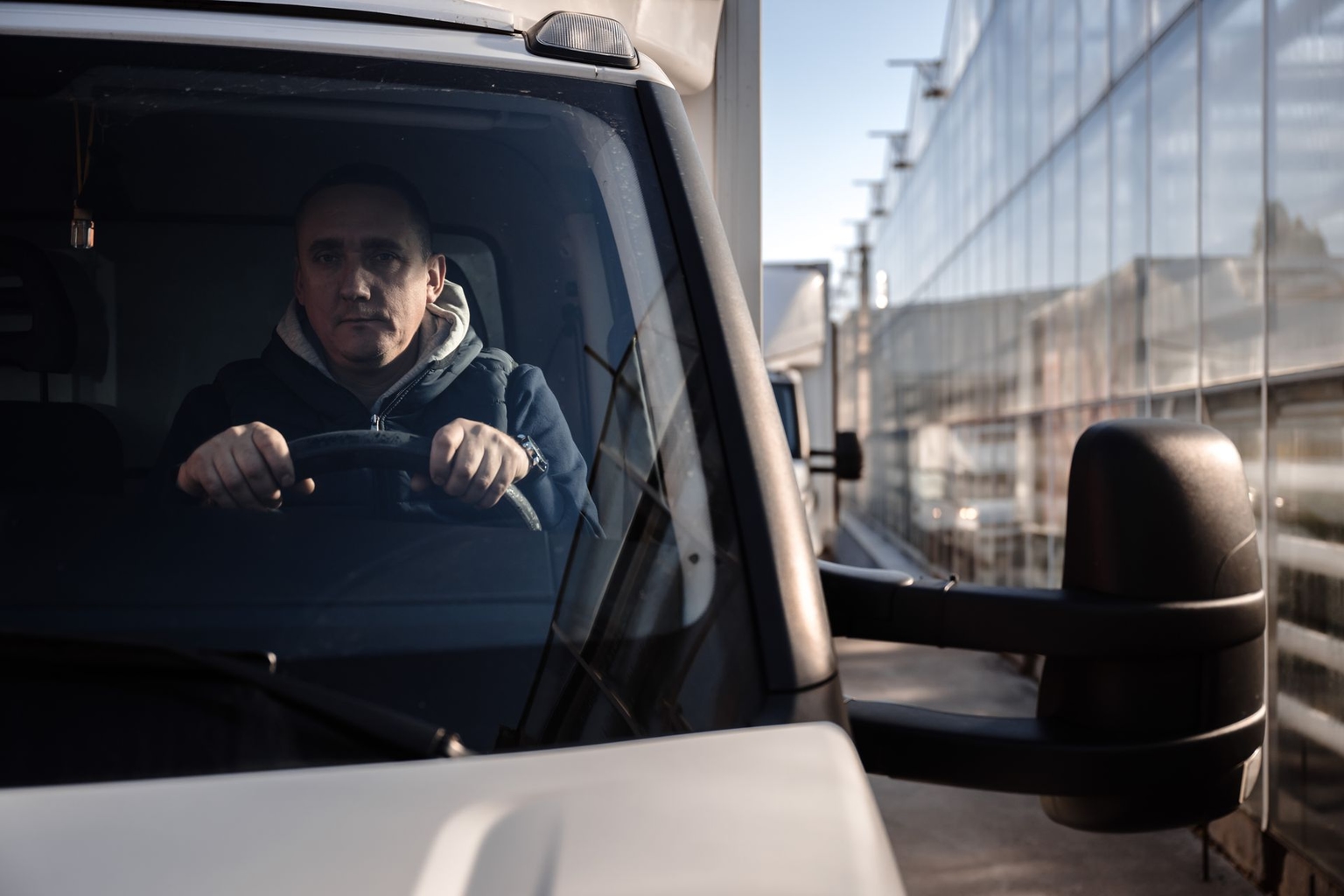 Vadym Kostenko, a driver, in his delivery truck next to a warehouse of Ascania-Flora, Ukraine's biggest producer of roses, near Kyiv, Ukraine, on Nov. 7, 2024.