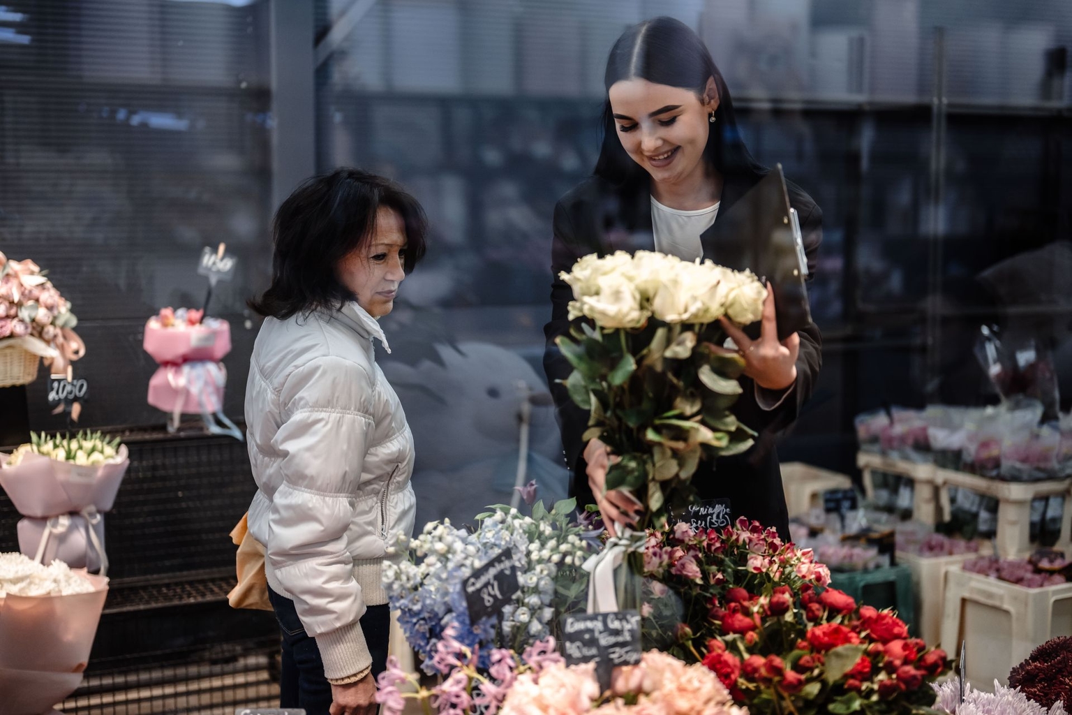 Olena Holovach, a customer at the Flora de Luxe flower shop in Kyiv, Ukraine, picks out flowers for her sister’s birthday on Nov. 7, 2024.