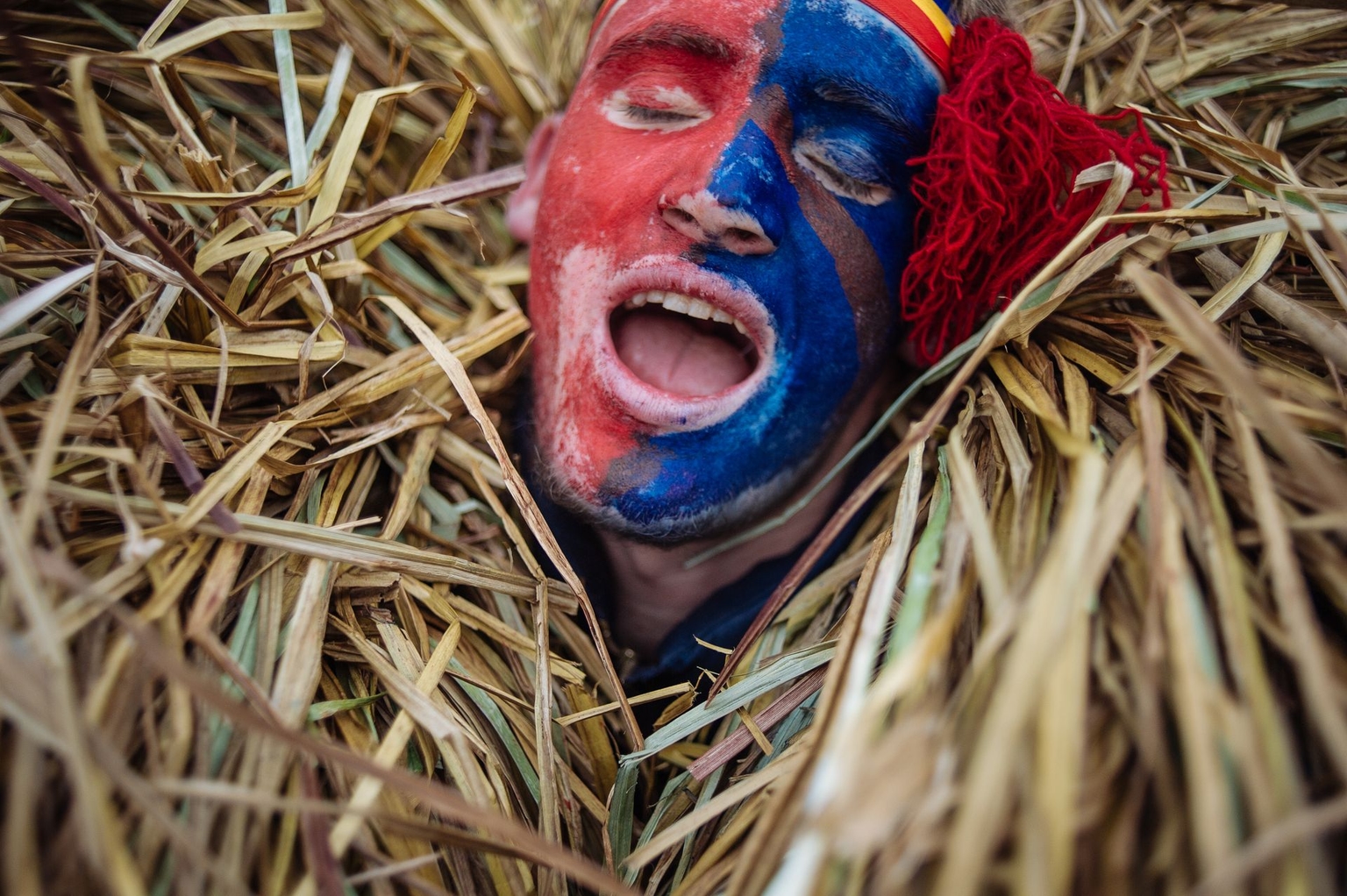 A man dressed in a Malanka costume sings during the Malanka holiday celebration in Krasnoilsk, Chernivtsi Oblast, Ukraine, on Jan. 14, 2014.