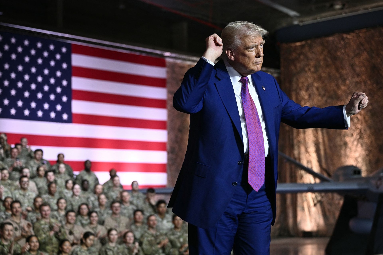 U.S. President Donald Trump gestures as he arrives to address troops at Al-Udeid Air Base southwest of Doha, Qatar, on May 15, 2025.