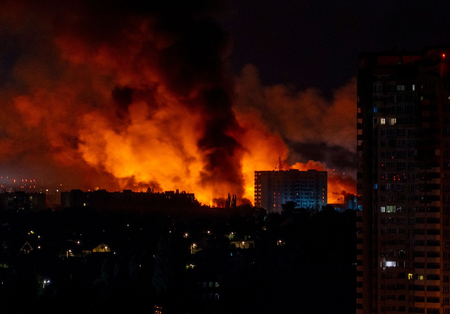 Flames and smoke billow from buildings during a mass Russian drone and missile strike on Ukraine’s capital, as Russia intensified aerial attacks amid the ongoing invasion of Ukraine.