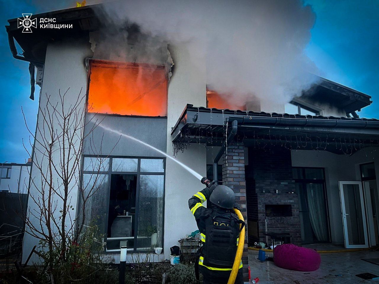 A firefighter puts out a fire in Kyiv Oblast on Dec. 23, 2025, following a Russian mass attack.