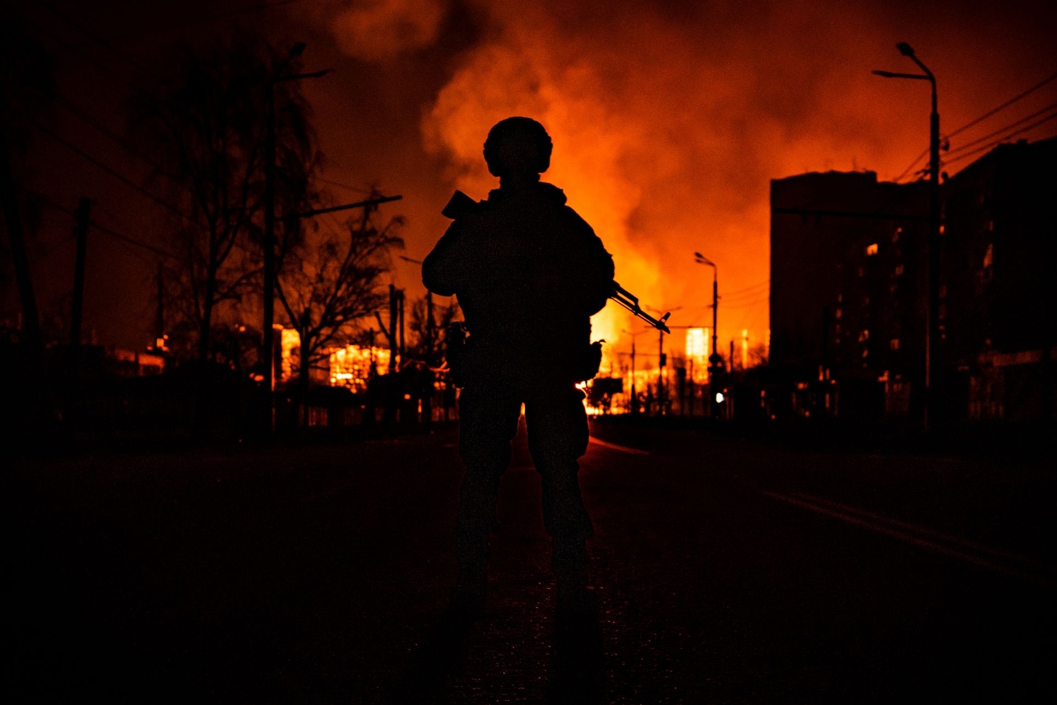 A member of Ukraine’s special forces stands in silhouette following Russian attacks in Kharkiv, Ukraine, on March 30, 2022.