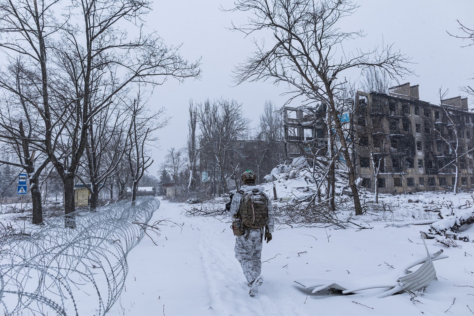 Ukrainian serviceman from the 24th Brigade, walks in front of a building damaged by Russian bombing in Kostiantynivka, Donetsk Oblast, Ukraine, on Dec. 28, 2025.