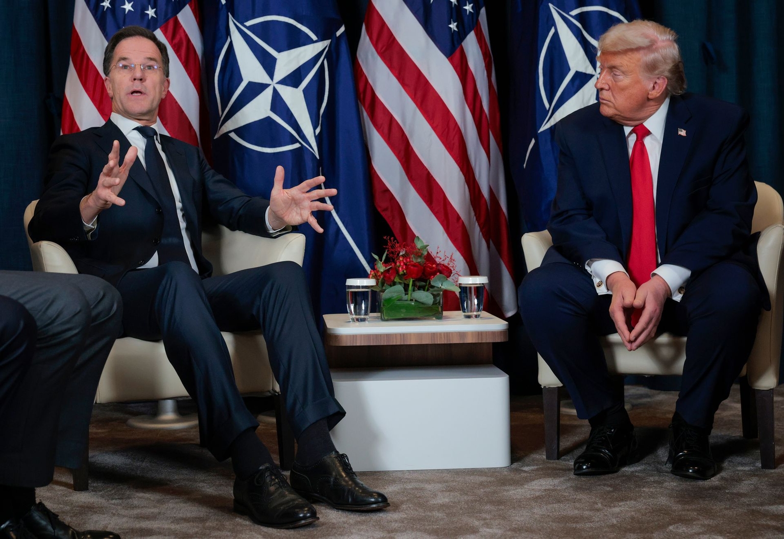 U.S. President Donald Trump (R) listens as NATO Secretary General Mark Rutte (L) speaks during a meeting in Davos, Switzerland, on Jan. 21, 2026.