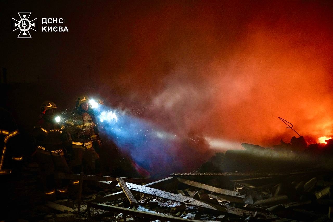 Emergency workers respond to a fire sparked by Russia's mass missile and drone attack on Kyiv, overnight on Jan. 9, 2025. 