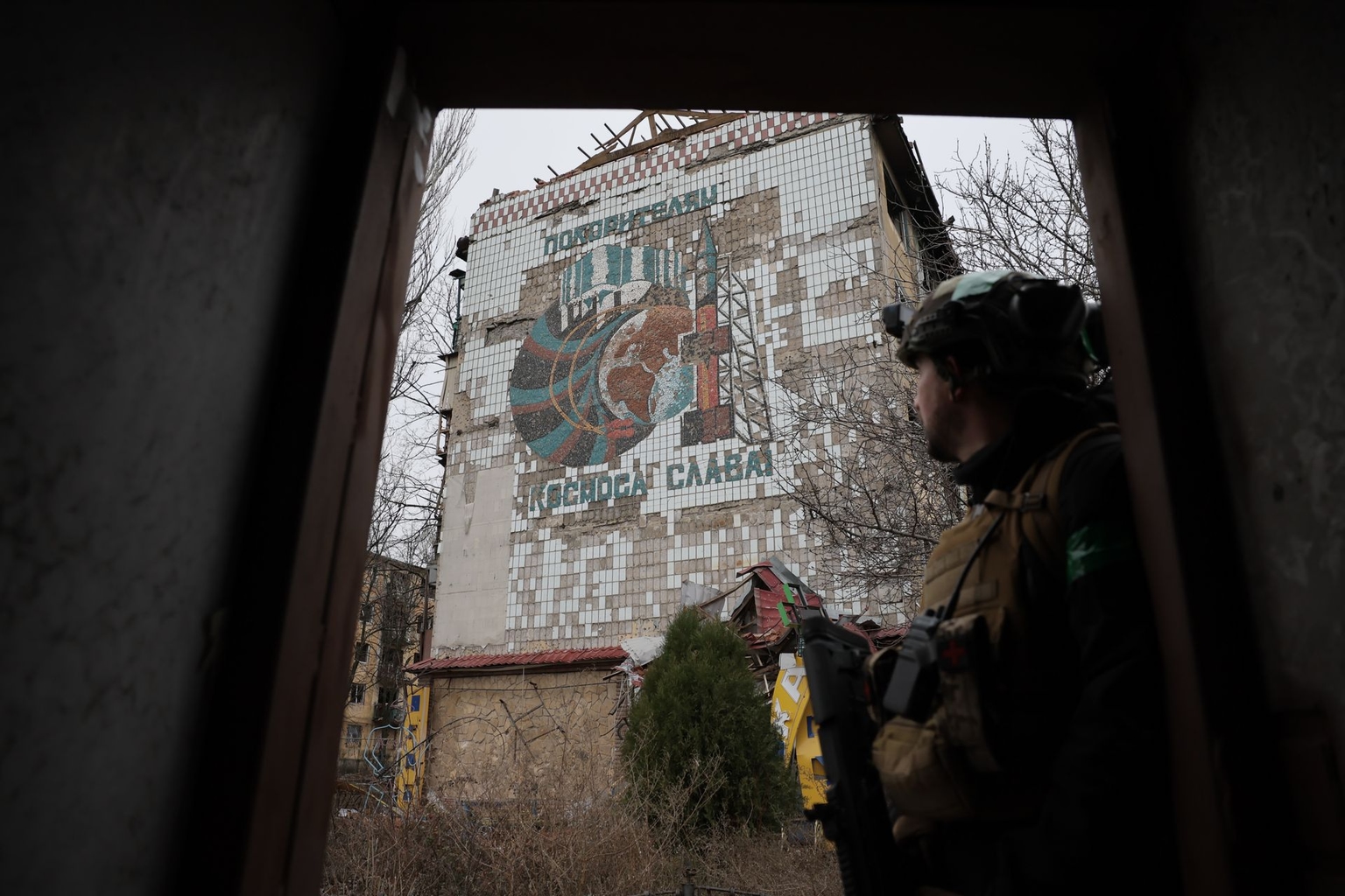 A Ukrainian soldier looks at mosaics in Kostiantynivka, Donetsk Oblast, Ukraine, on Dec. 21, 2025.