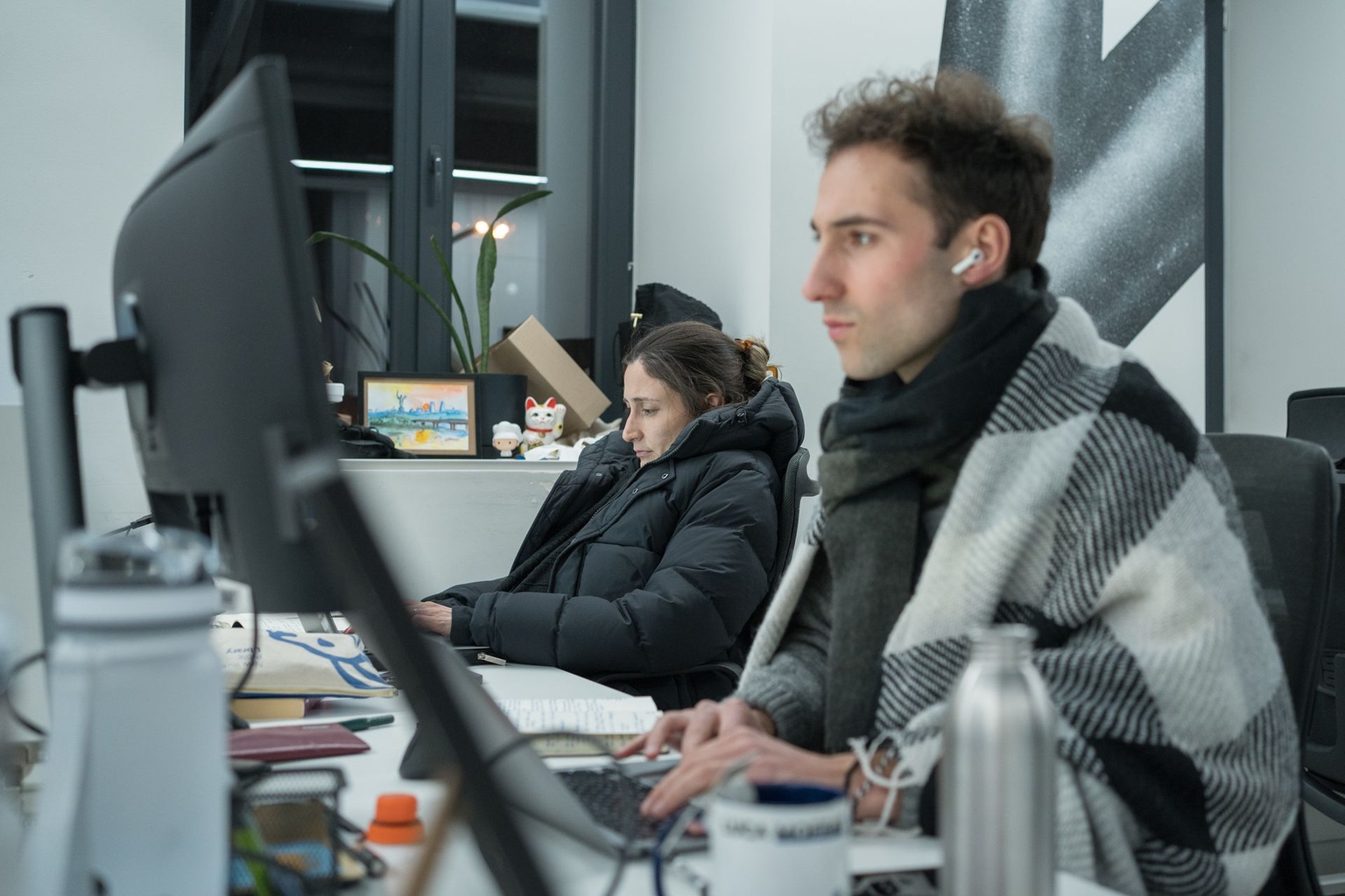 Lili Bivings (L) and Luca Léry Moffat (R) of The Kyiv Independent’s business desk work in the newsroom in Kyiv, Ukraine, on Jan. 14, 2026.