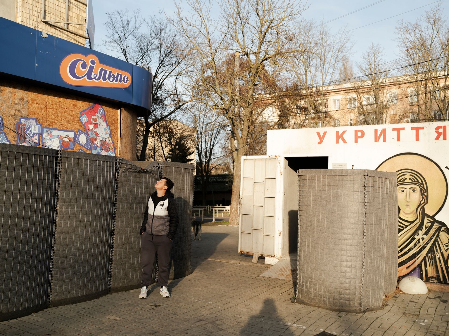 A Kherson resident stands near a shelter in Kherson, Ukraine, on Nov. 21, 2025.