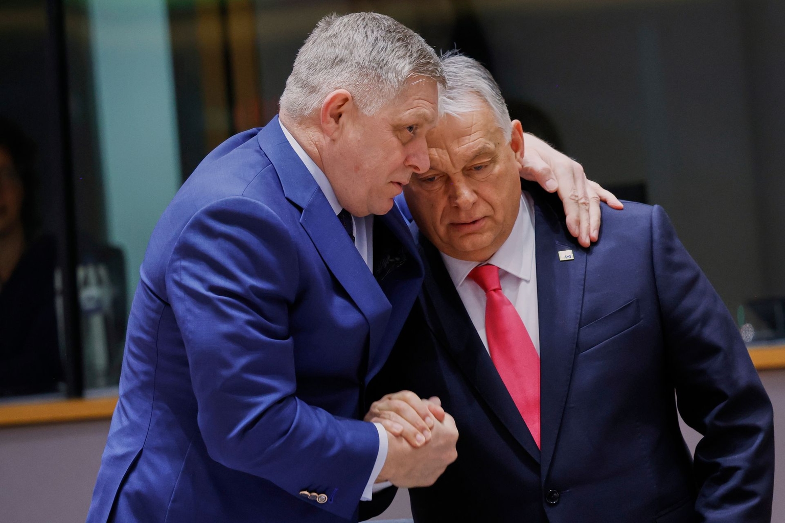 Slovak Prime Minister Robert Fico (L) speaks with Hungarian Prime Minister Viktor Orbán (R) during a roundtable meeting at an EU summit in Brussels, Belgium, on March 20, 2025. 