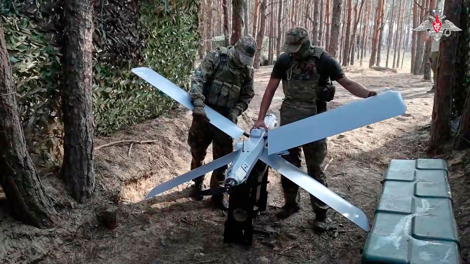 Russian soldiers hold a Lancet drone in an undisclosed location in Ukraine.