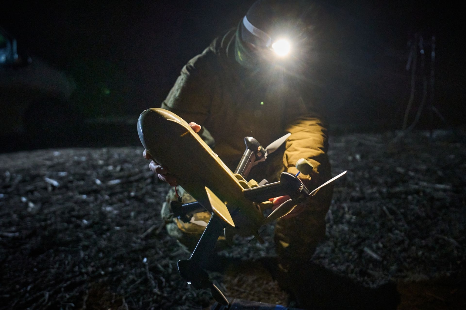 A Ukrainian soldier prepares an interceptor drone during a Russian aerial attack at an undisclosed location in Ukraine on Dec. 13, 2025.