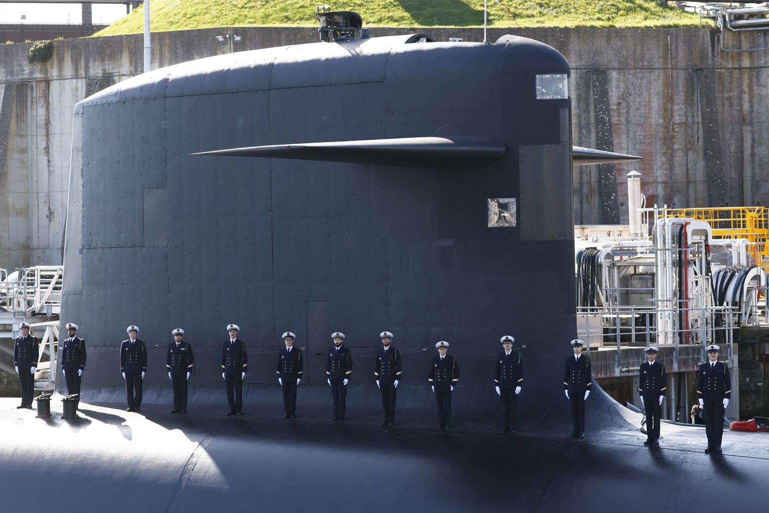 Members of the French Navy stand on the topside of a submarine ahead of President Emmanuel Macron’s visit to the Île Longue nuclear submarine base in Crozon, France, on March 2, 2026. 