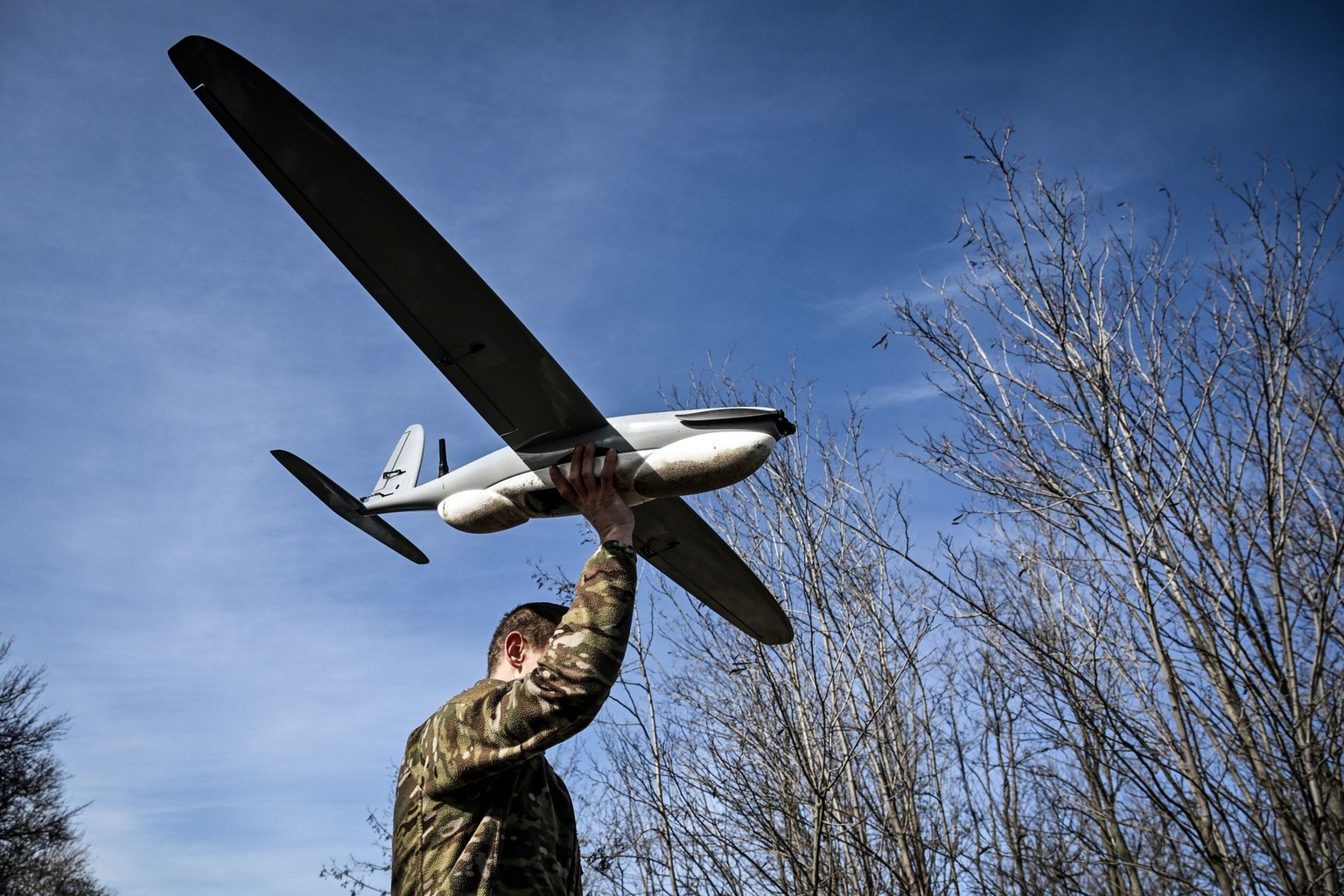 A soldier launches an RQ-35 Heidrun drone used for reconnaissance and artillery fire correction in the Zaporizhzhia Oblast, Ukraine on Feb. 22, 2026. 