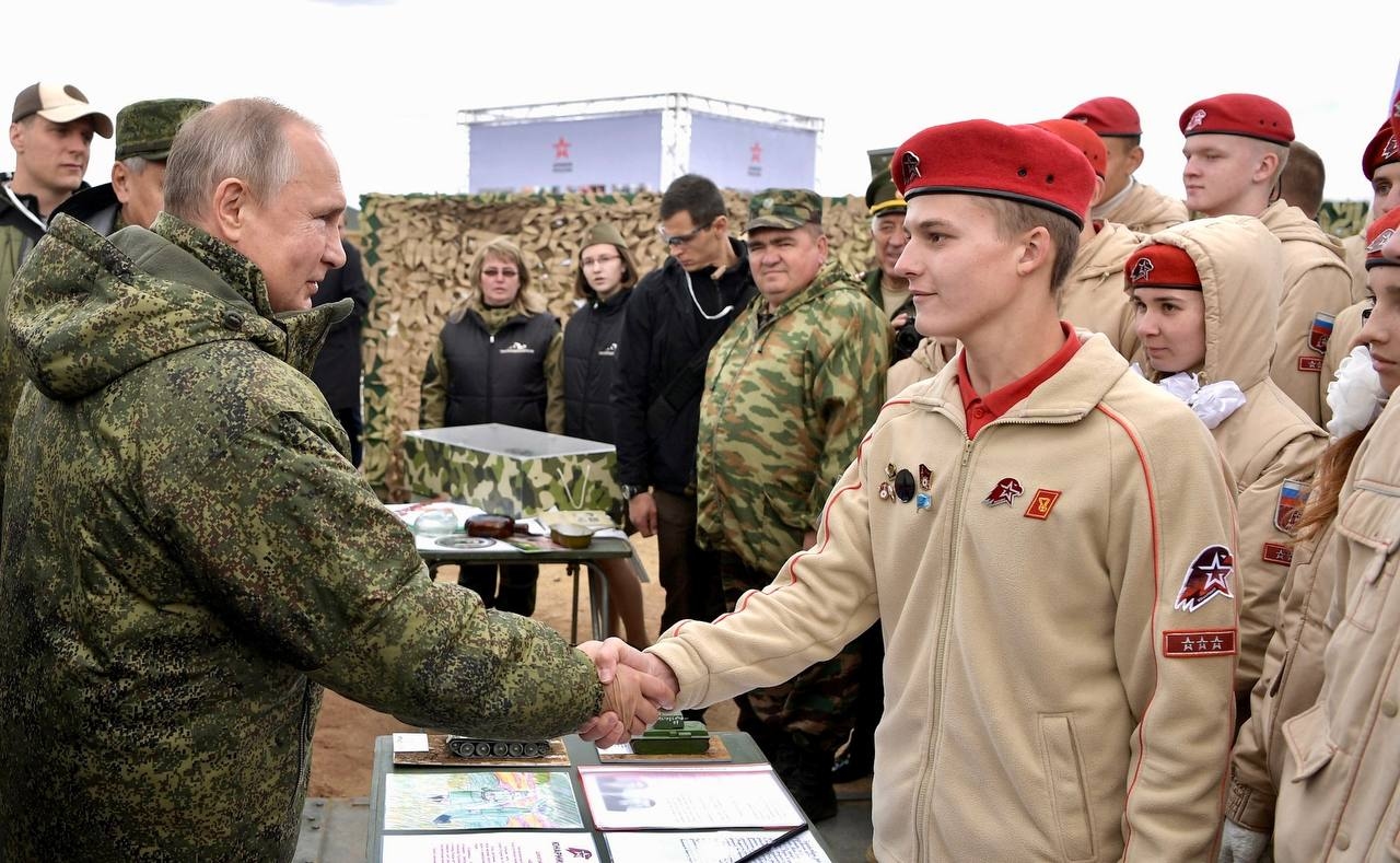 A member of the all-Russian military-patriotic organization "Youth Army" (Yunarmiya) shakes hands with Russian President Vladimir Putin, in a photo published on Feb. 7, 2026. 