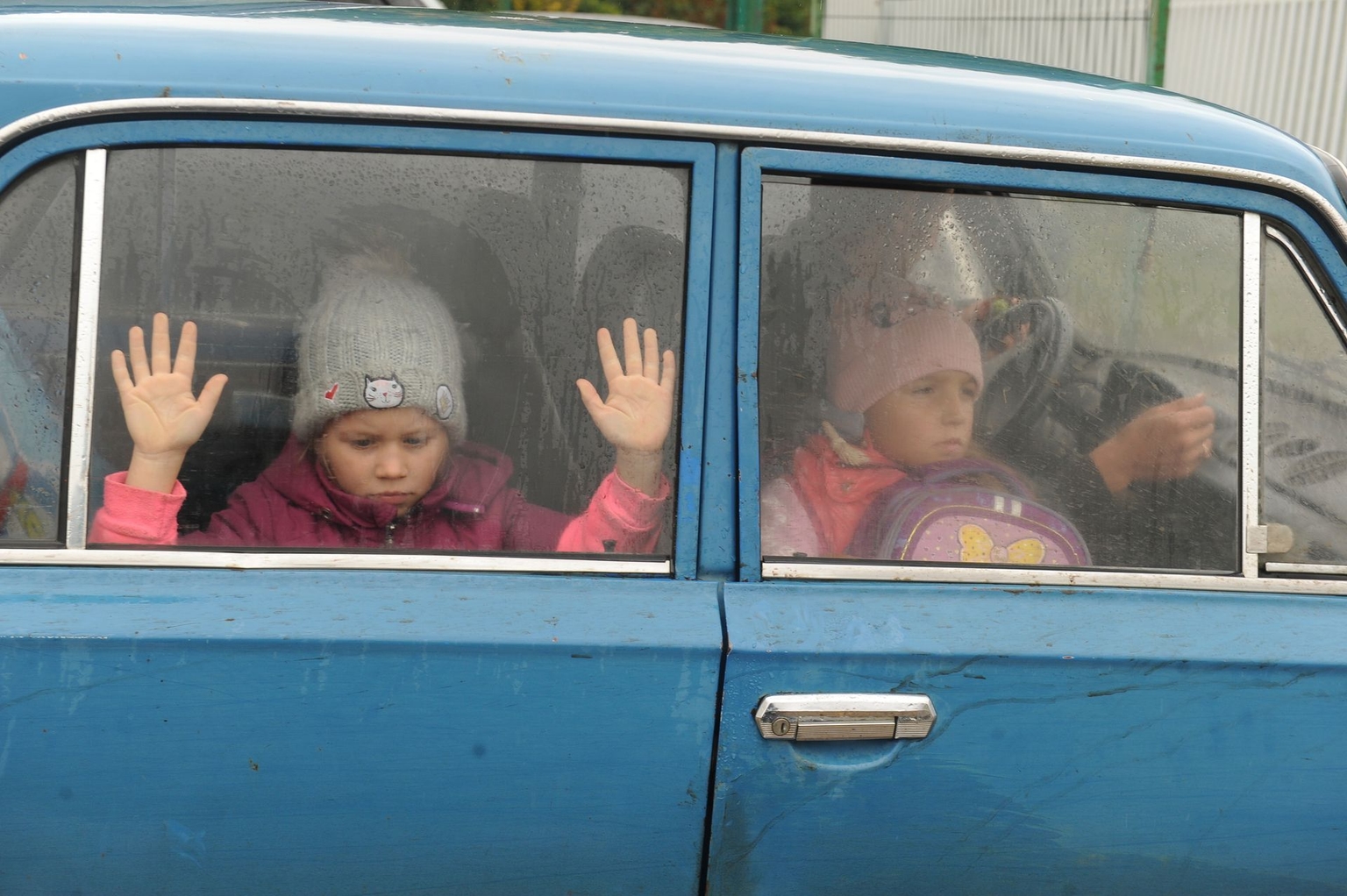 Children look through car windows as they, along with other people from Kharkiv Oblast, Ukraine, arrive at a temporary camp in Belgorod, Russia, on Sept. 14, 2022.