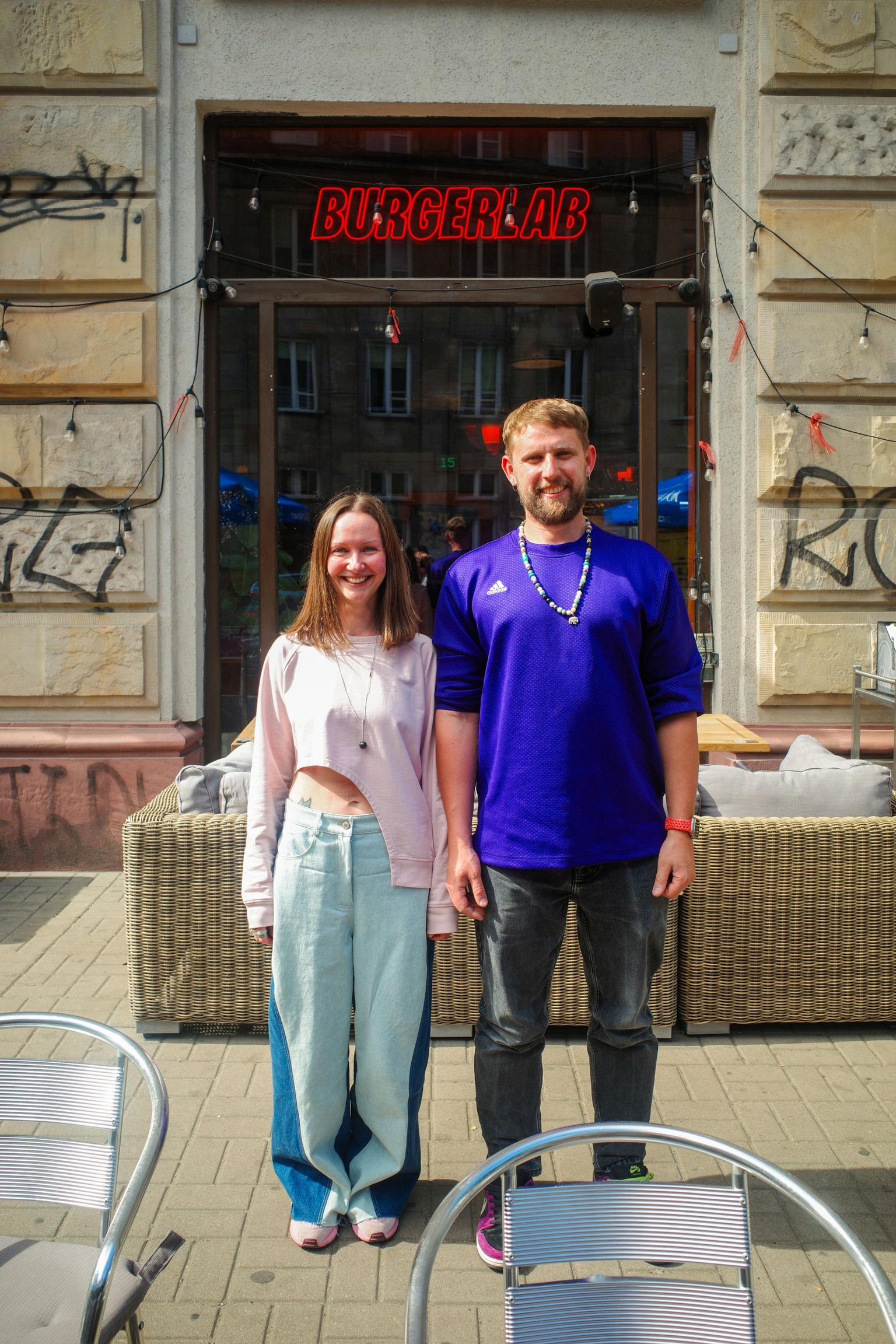 Slava B., owner of Burger Lab, and Anna K., the restaurant's digital marketing manager, pose on the restaurant's terrace in Warsaw, Poland, on May 29, 2026. 