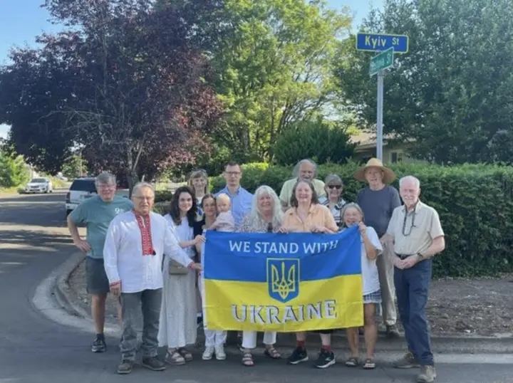 Community members in Springfield, Oregon, U.S., celebrate the unveiling of a street sign changed from the Russian spelling "Kiev" to the Ukrainian "Kyiv."