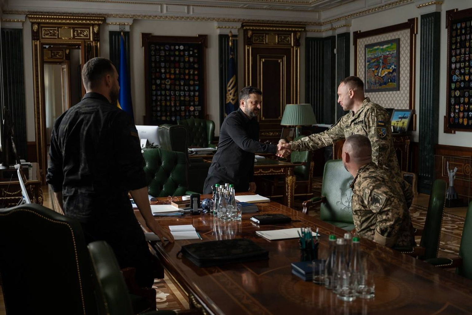 President Volodymyr Zelensky (C) shakes hands with Commander-in-Chief of Ukraine's Armed Forces Mykhailo Drapatyi during their meeting in Kyiv, Ukraine, on July 20, 2026. 