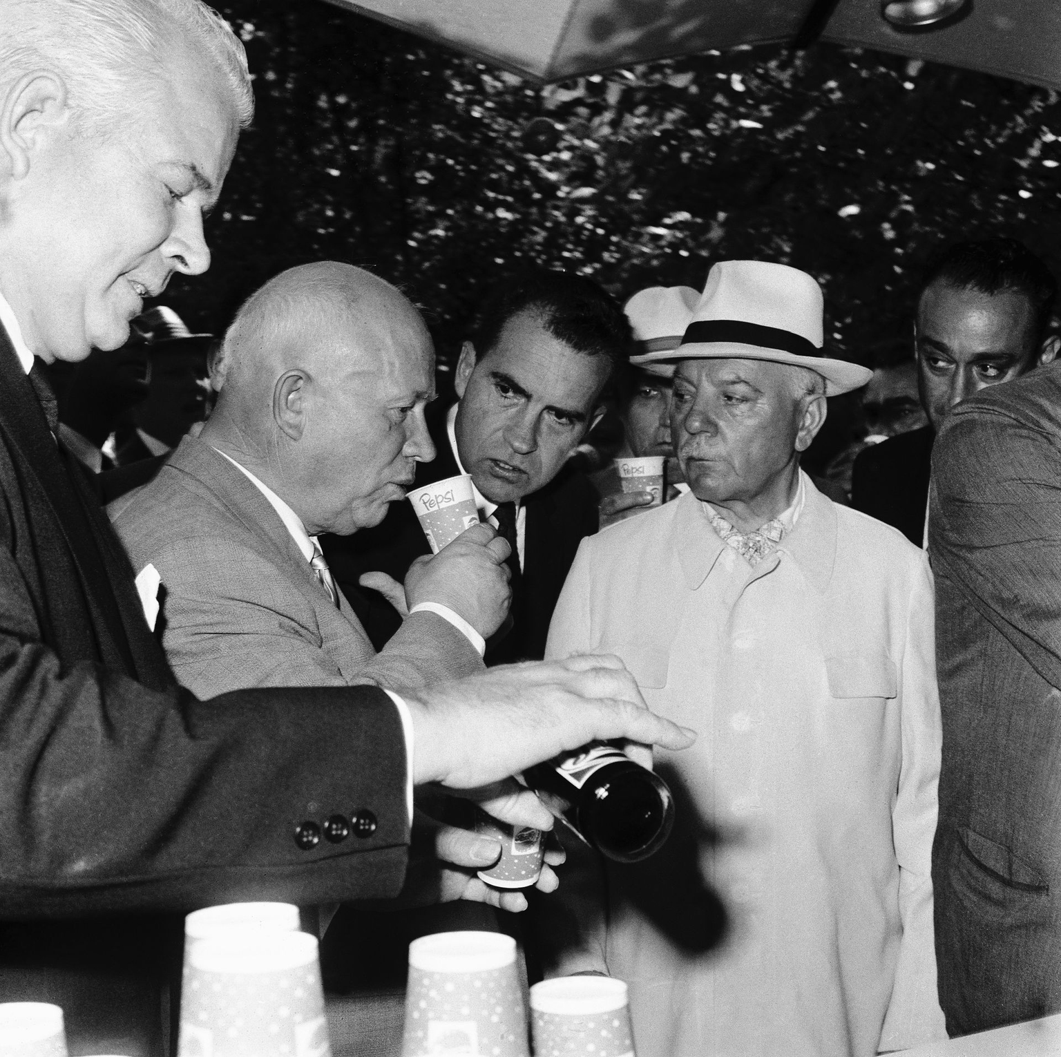 Khrushchev samples Pepsi-Cola as Nixon looks on in Moscow, USSR, in 1959.