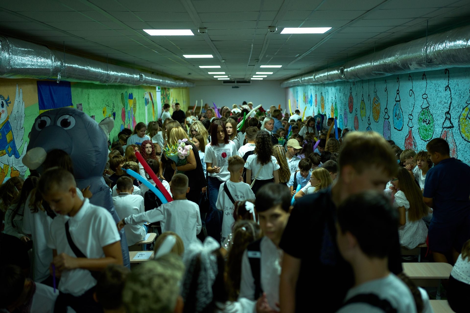 Children, parents and teachers stay in an underground shelter during an air raid alarm during traditional back-to-school celebrations in Kyiv, Ukraine, on Sept. 1, 2026. 