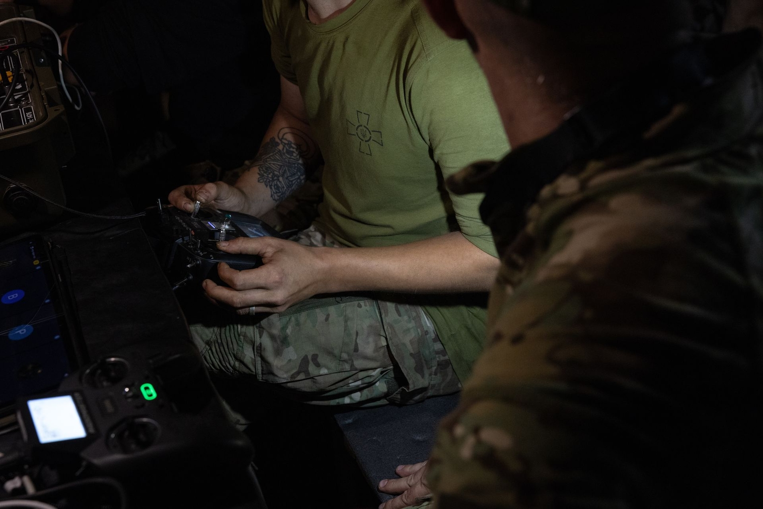 Intelihent, a combat wing operator, works the controls in the dugout, in the Lyman sector, Ukraine, on Aug. 11, 2026. 