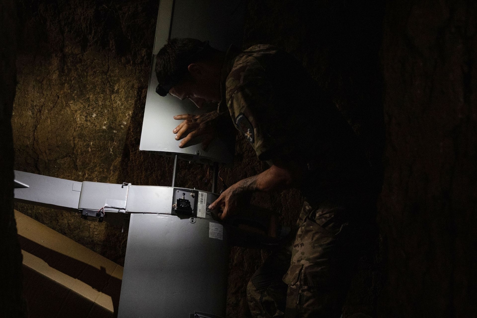 Tsyhan and Kalash, combat wing operators, set the drone up for launch in the Lyman sector, Ukraine, on Aug. 11, 2026.