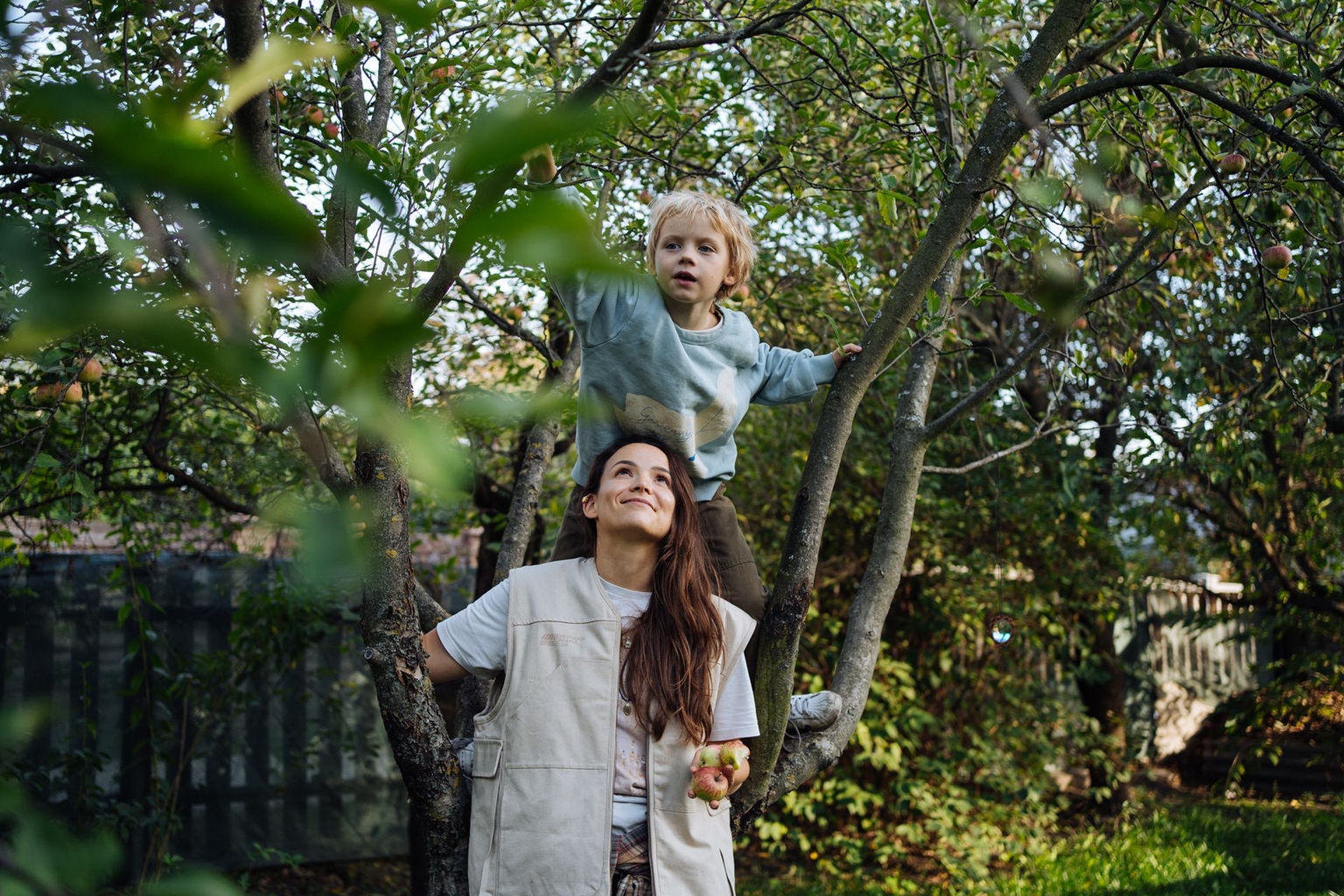 Nina Shkurba, a writer and mother, with her s 9-year-old son Veniamin, in the garden of their dacha in the Osokorky neighborhood of Kyiv, Ukraine, on Oct. 4, 2026.