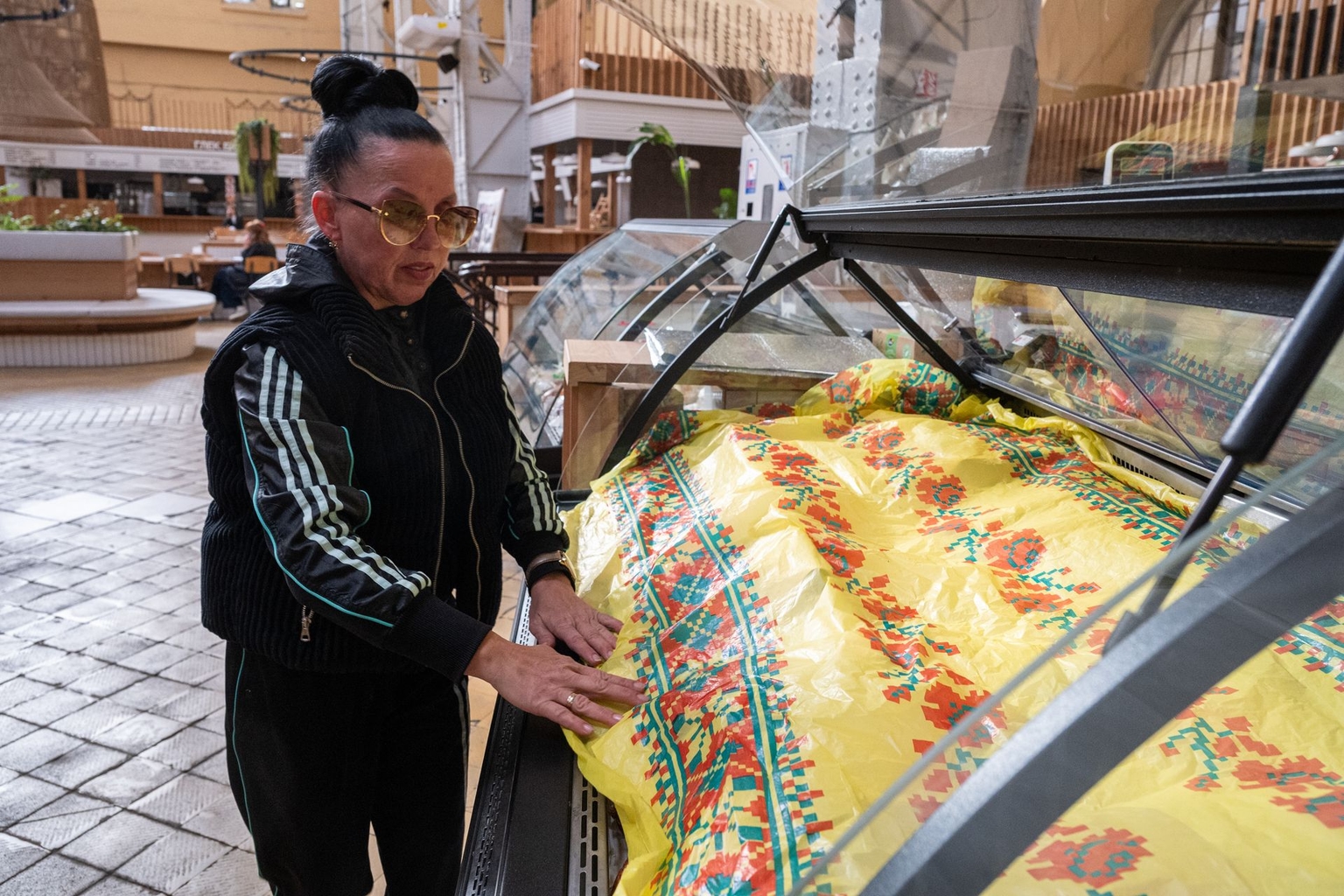 Natalia covers products at Bessarabskyi Market during a power outage in Kyiv, Ukraine, on Oct. 6, 2026.
