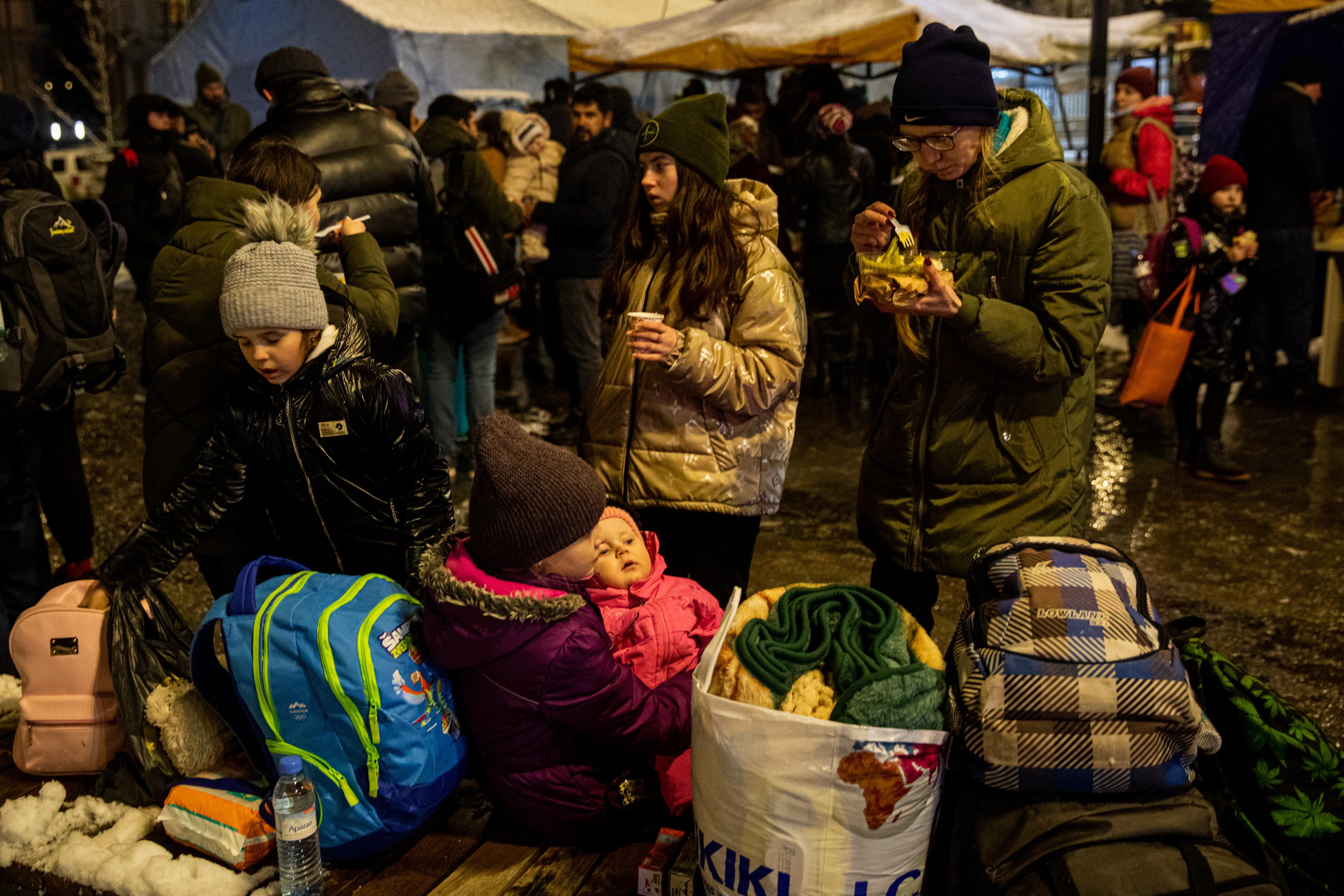 Ukrainians flee war by train, car, on foot