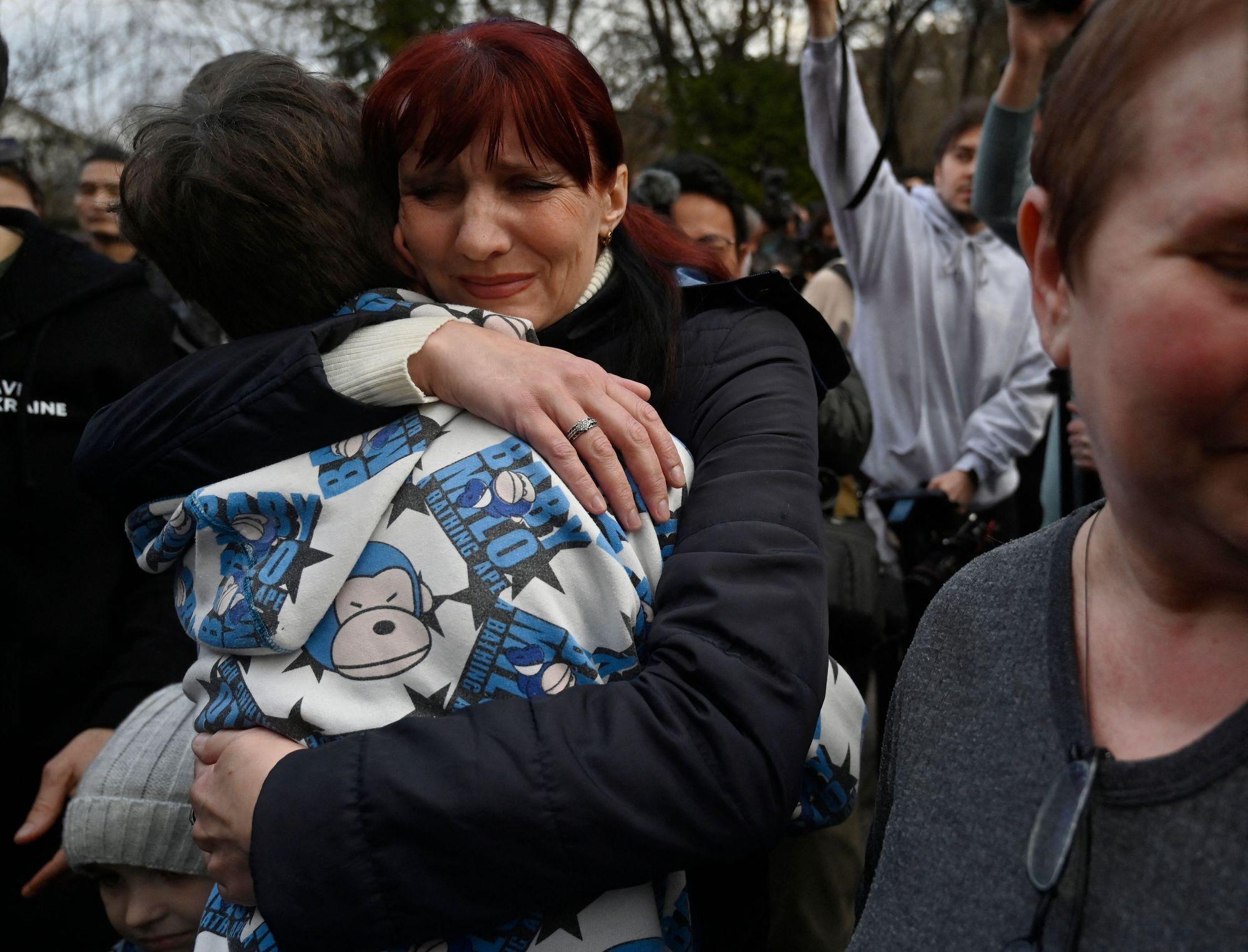 A Ukrainian woman meets her son Vitaly after he was brought back from Russian-held territory to Kyiv on March 22, 2023. 