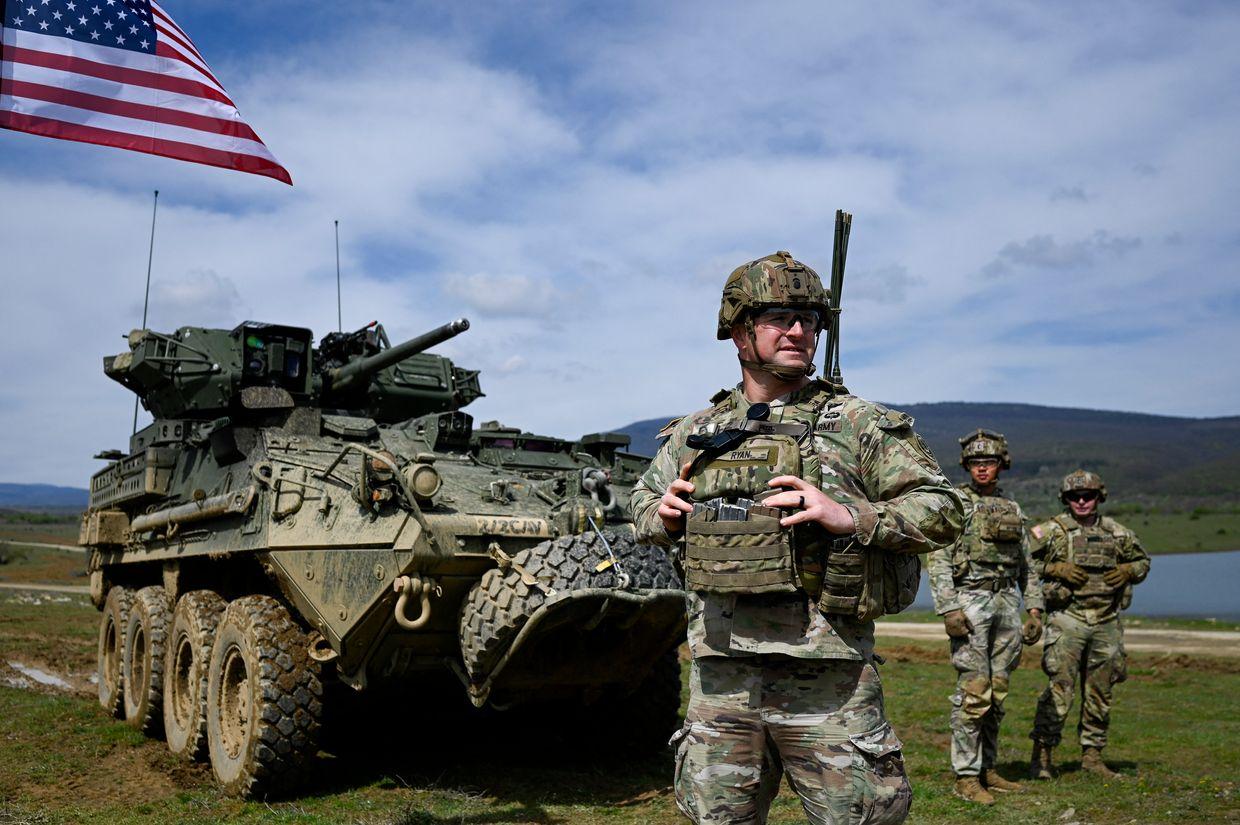 US soldiers stand next to vehicle as they take part in a NATO joint military exercise with Bulgaria's army at Novo Selo