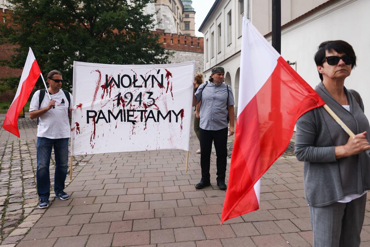 People hold flags and a banner reading "Volhynia. 1943. We remember"