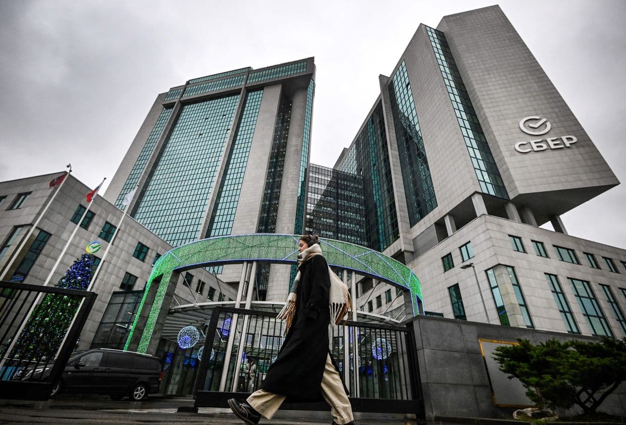 A woman walks past Sber Bank's headquarters in Moscow, Russia, on Nov. 14, 2023.