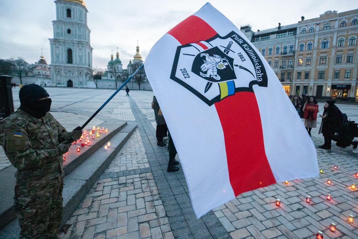 Belarusian volunteers wave the Kalinouski Regiment flag during a protest in Sofia Square, Kyiv, Ukraine, on March 14, 2023.