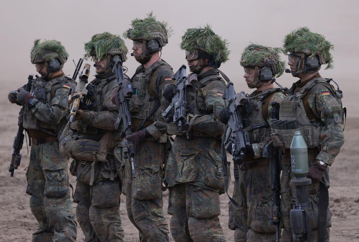German Bundeswehr troops stand during the Quadriga military exercises in Pabrade, Lithuania, on May 29, 2024. 