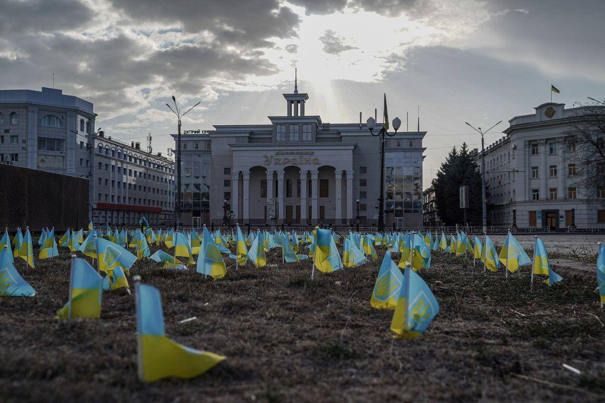 Ukrainian flags at a war memorial in central Kherson, Ukraine, on Oct. 2, 2024. The city faces constant Russian shelling. 