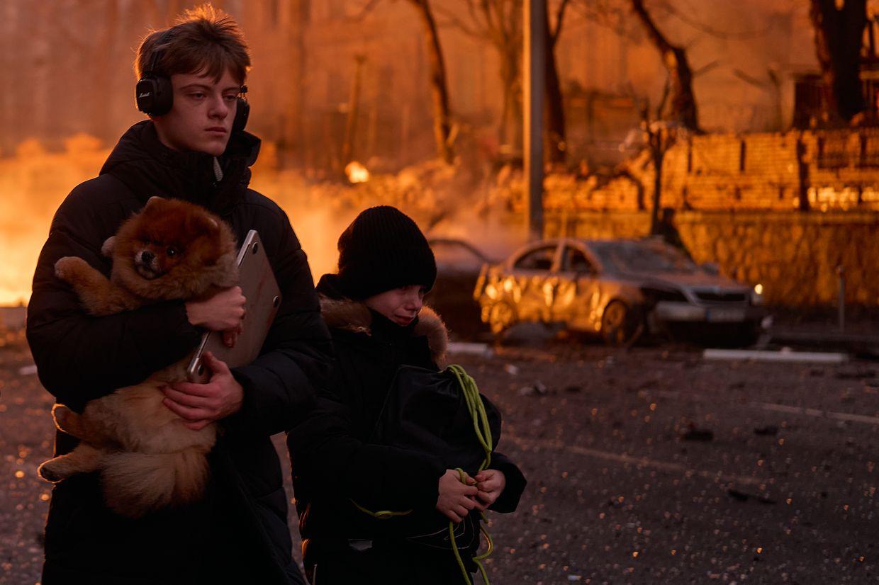 Civilians carry a dog after a Russian ballistic missile strike on the city center in Kyiv, Ukraine, on Dec. 20, 2024.