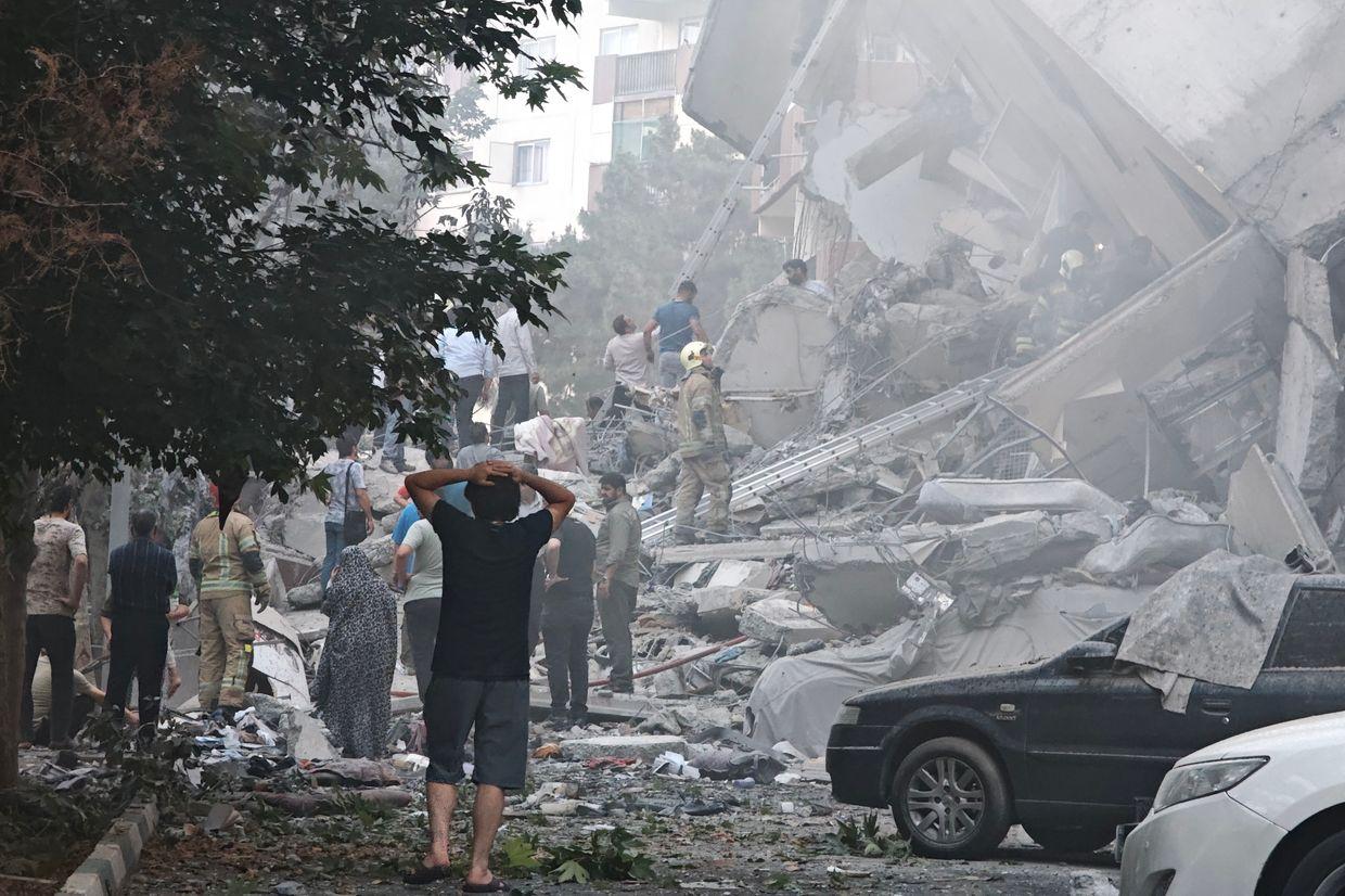 People look over damage to buildings in Nobonyad Square following Israeli airstrikes in Tehran, Iran, on June 13, 2025. 