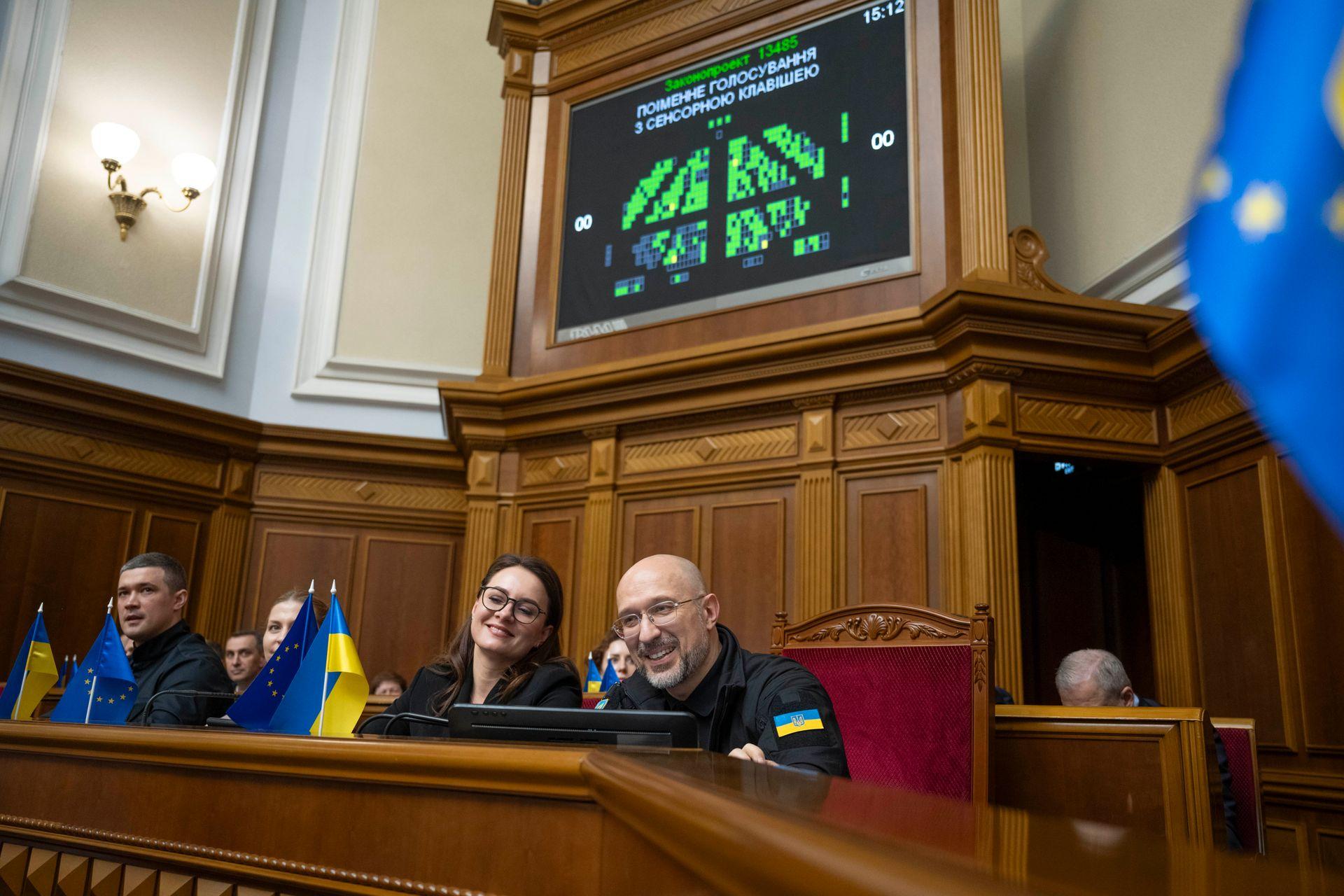 Denys Shmyhal (R) and Yulia Svyrydenko (L) smile in the Verkhovna Rada in Kyiv, Ukraine, on July 16, 2025. 
