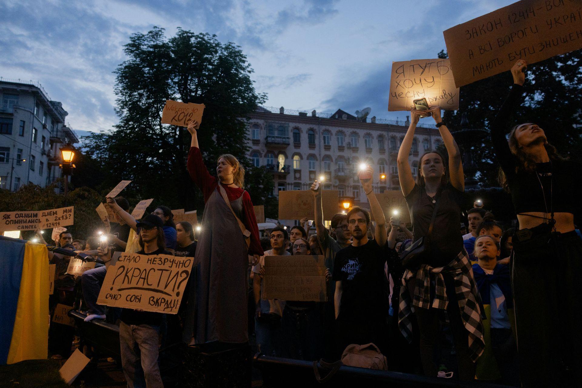 Protesters hold placards during a protest in downtown Kyiv, Ukraine, on July 22, 2025. 