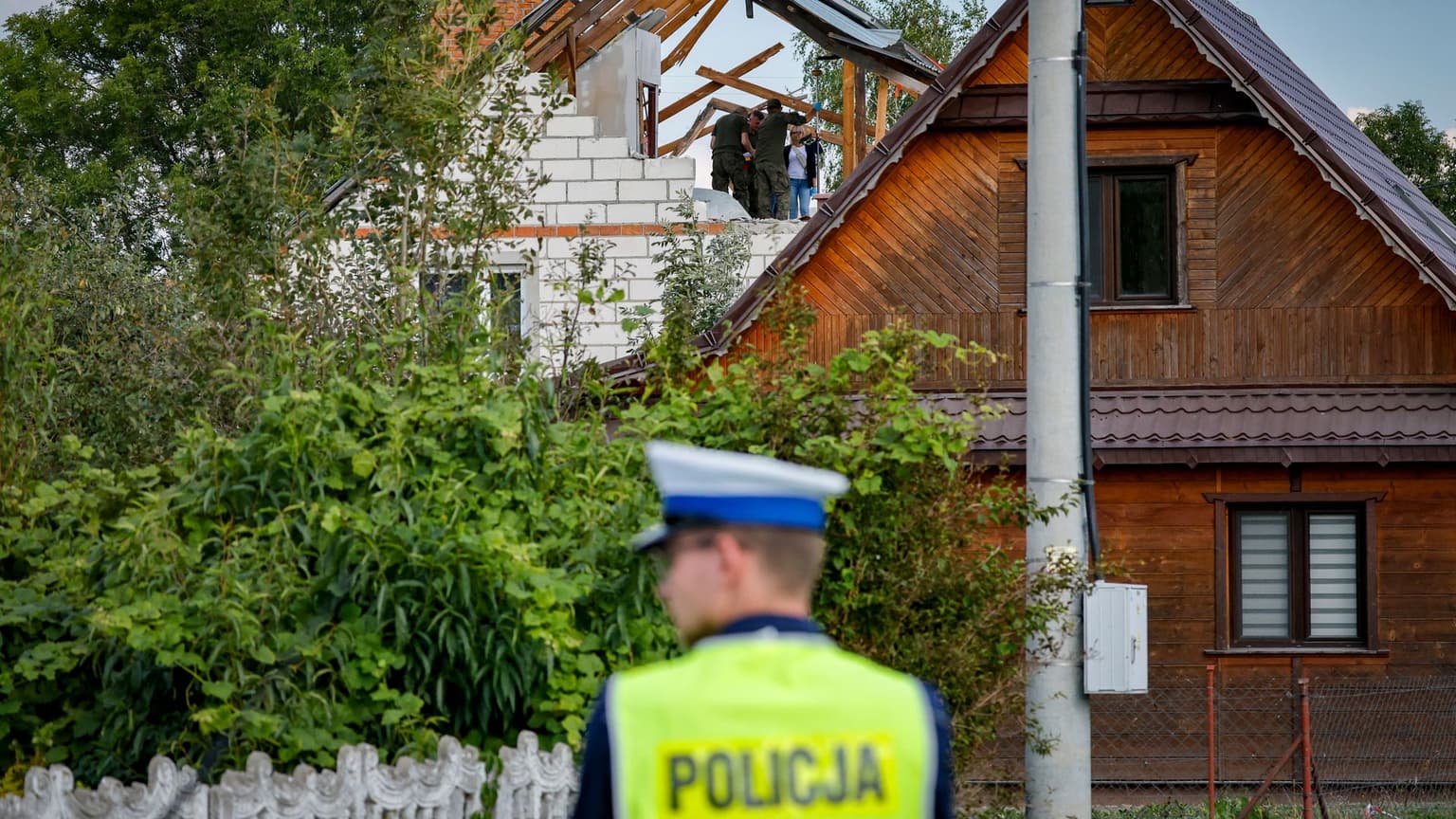 Police and army inspect the damage to a house in Wyryki-Wola, Poland, on Sept. 10, 2025.