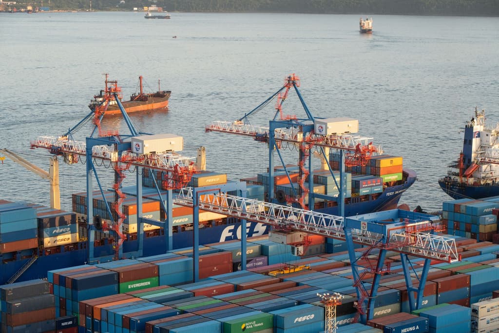 A Russian-flagged cargo ship docked at a port, unloading military-grade armored vehicles destined for the Mali military junta.