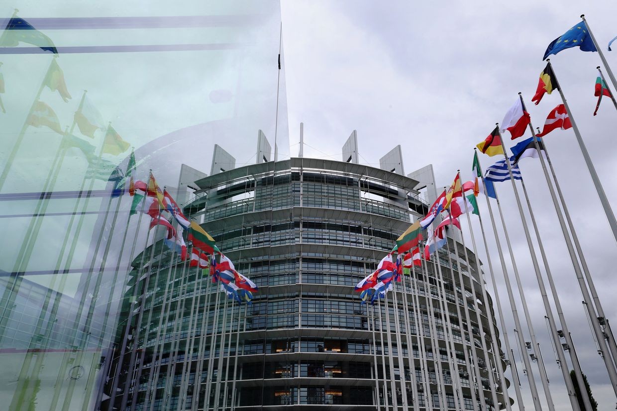 European Parliament building with flags of European countries. 