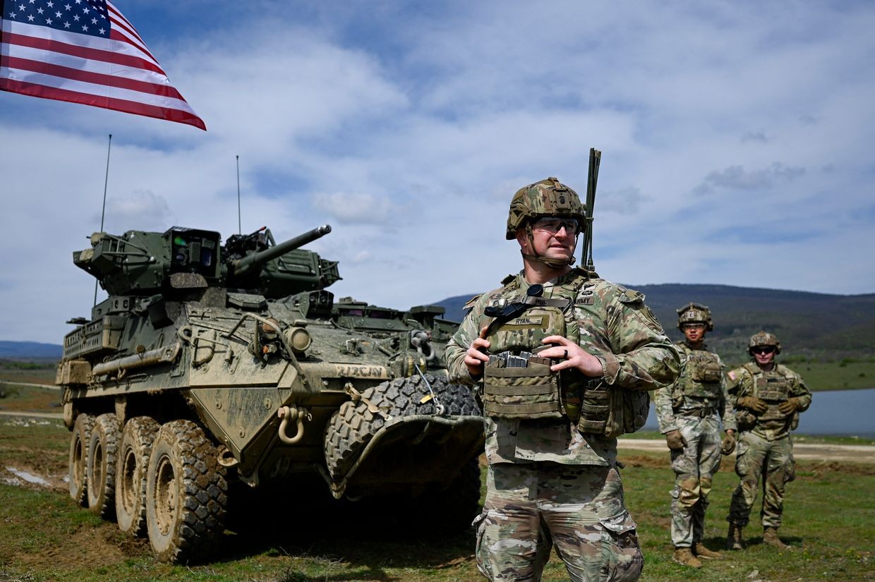 US soldiers stand next to vehicle as they take part in a NATO joint military exercise with Bulgaria's army at Novo Selo