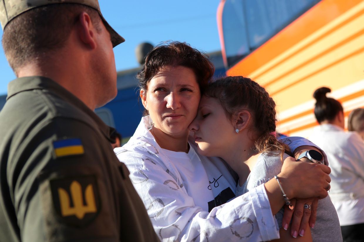 A woman hugs a girl at the Lviv railway station in Lviv, Ukraine on Aug. 4, 2022.