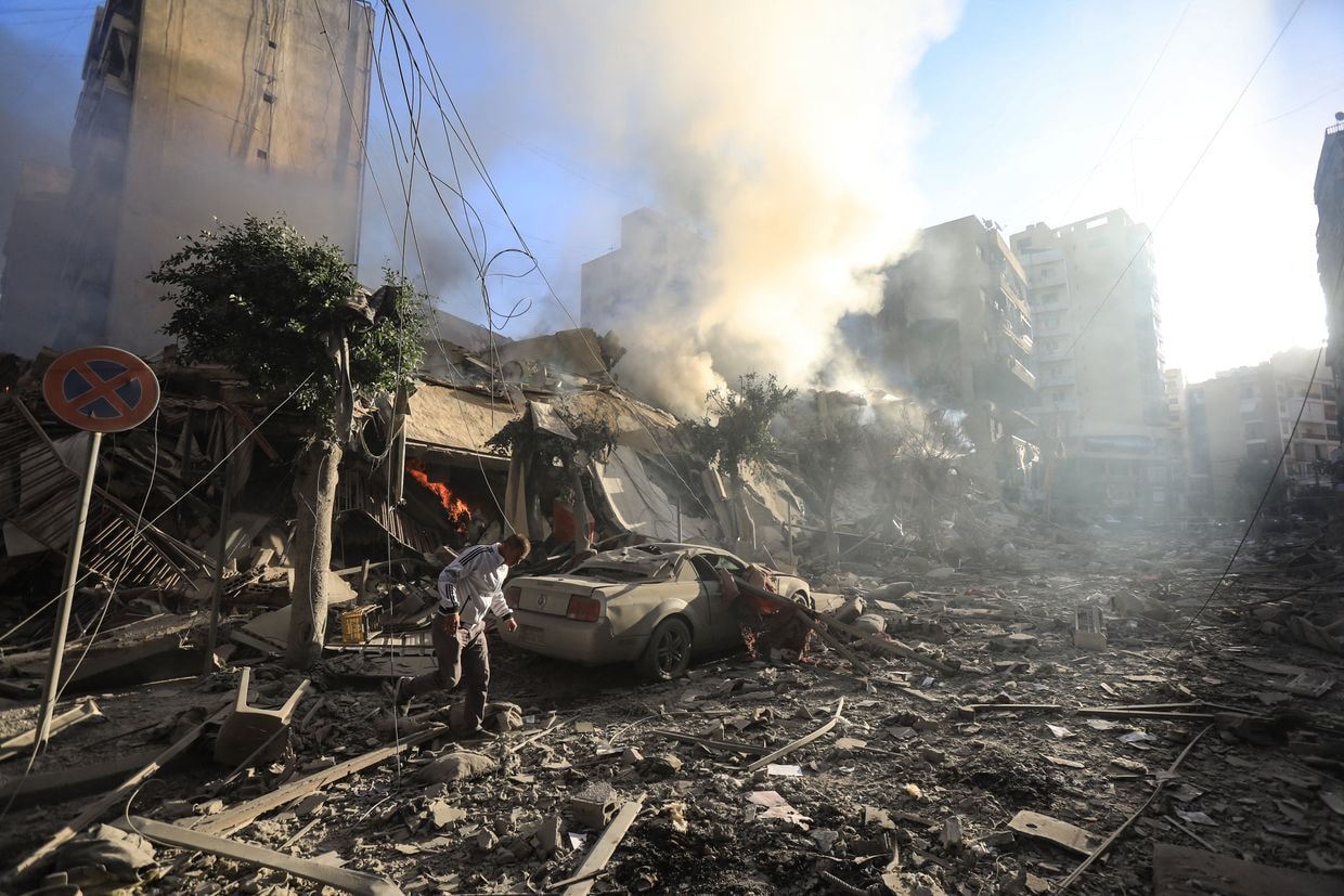 A man walks amid the rubble of a building hit in an overnight Israeli airstrike of Lebanon