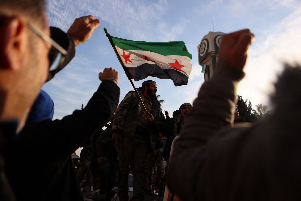  Syrian rebels celebrate at the Clock Tower in Homs on Dec. 8, 2024, after entering Syria's third-largest city overnight.