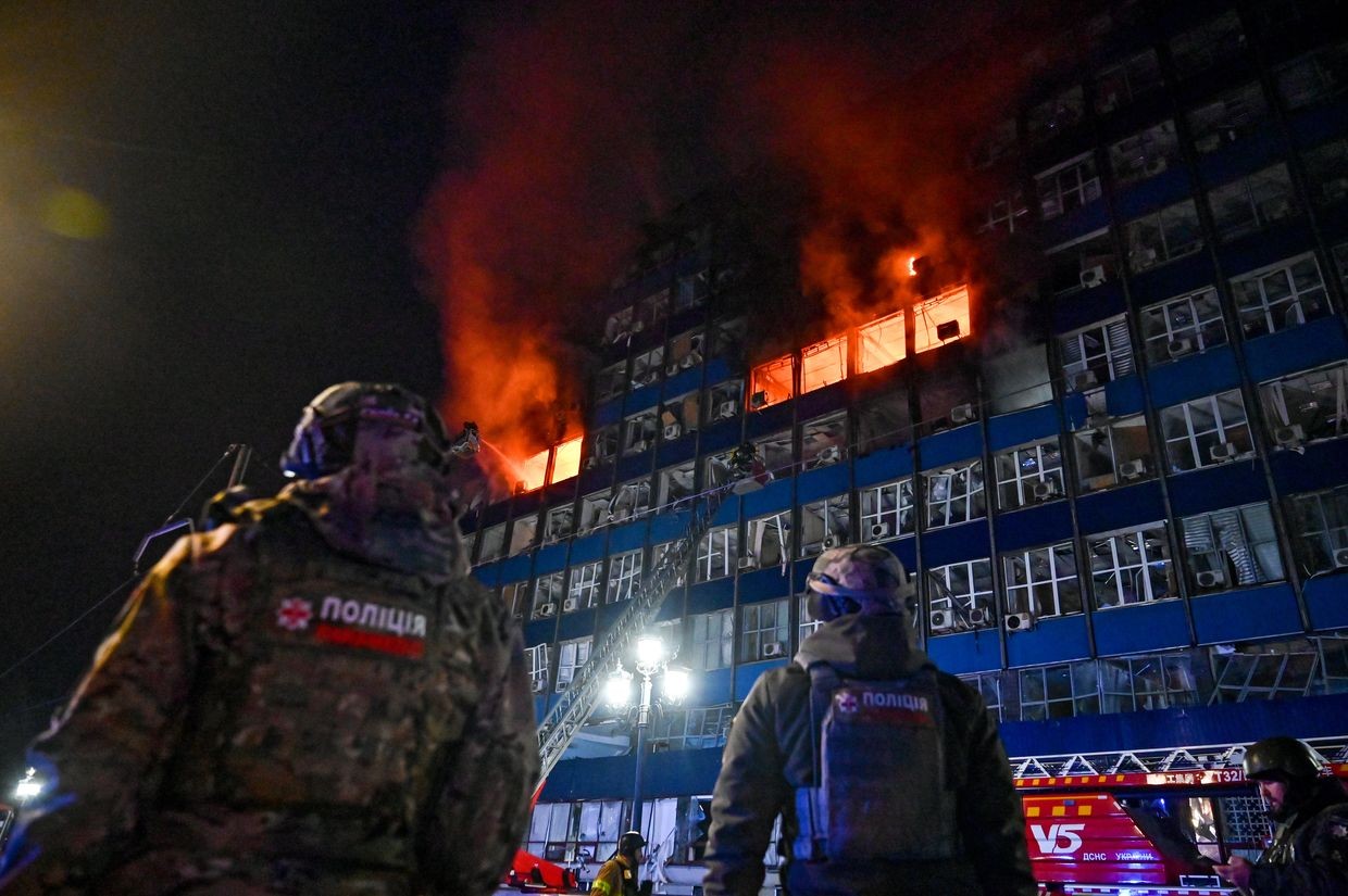 Police watch firefighters extinguish a fire from a Russian airstrike on Zaporizhzhia, Ukraine, on Jan. 8, 2025.