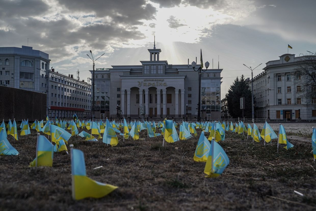 Ukrainian flags at a war memorial in central Kherson, Ukraine, on Oct. 2, 2024. The city faces constant Russian shelling. 